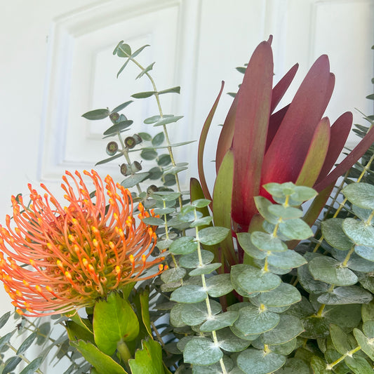 Safari Sunset Leucadendron, Spiral Baby Eucalyptus, and Pincushion Wreath