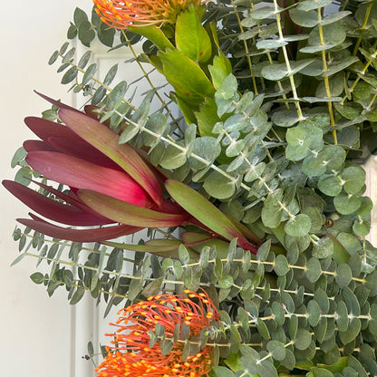 Safari Sunset Leucadendron, Spiral Baby Eucalyptus, and Pincushion Wreath