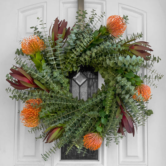 Safari Sunset Leucadendron, Spiral Baby Eucalyptus, and Pincushion Wreath